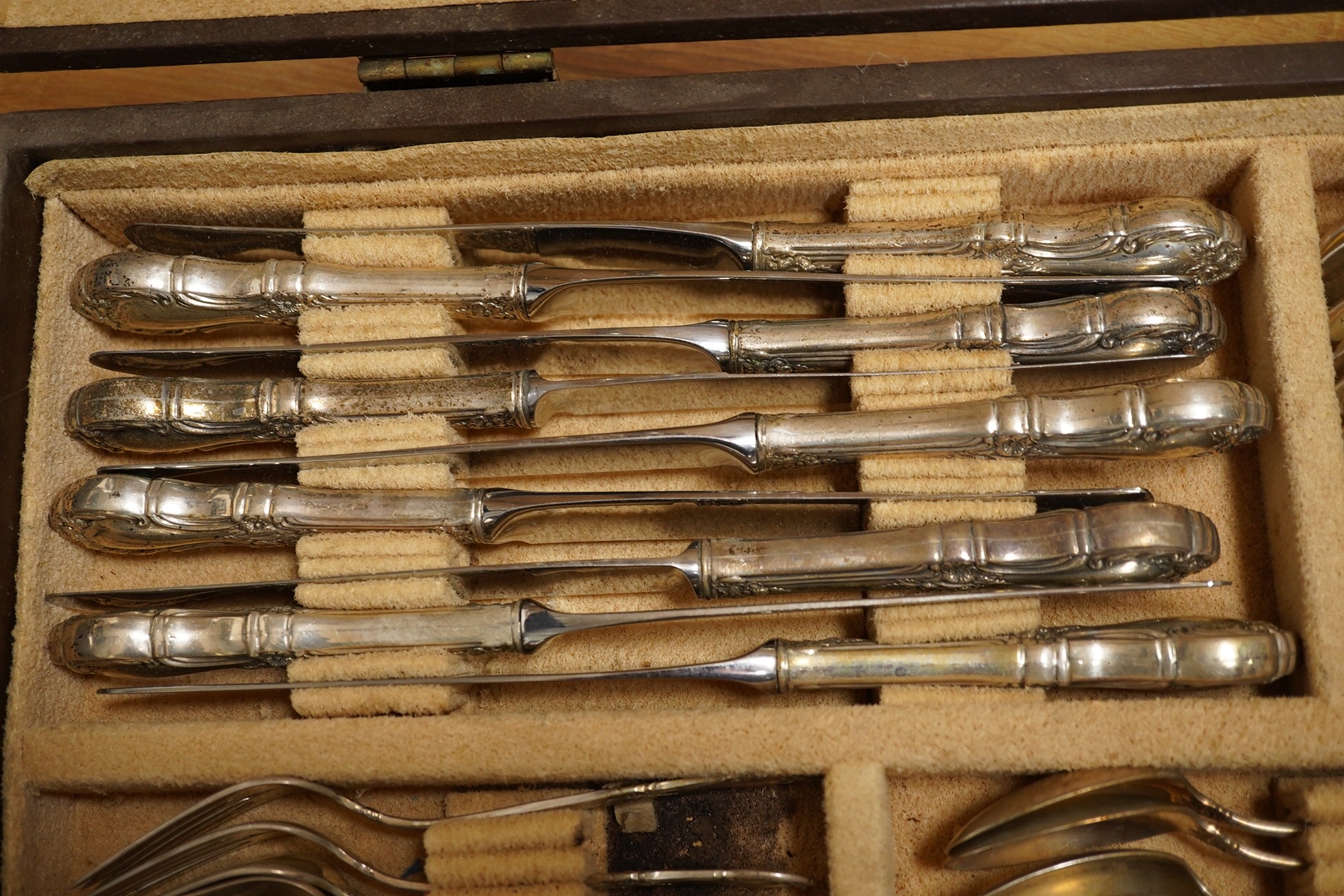 A cased part canteen of American sterling cutlery, weighable silver 63.8oz, together with four silver plated table forks. Condition - poor to fair